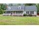 Beautiful home featuring a large covered front porch and well-maintained landscaping at 1401 Berea Rd, Rougemont, NC 27572