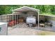 A versatile garage or shed provides covered storage for RV, equipment, and other outdoor essentials at 1401 Berea Rd, Rougemont, NC 27572