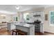 Beautifully updated kitchen with white cabinets, subway tile backsplash, and stainless steel appliances at 1401 Berea Rd, Rougemont, NC 27572