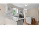 Modern kitchen features white cabinetry, granite countertops, stainless steel appliances, and ample lighting at 1401 Berea Rd, Rougemont, NC 27572