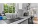 Bright kitchen with granite counters, stainless appliances, and a large window view at 1401 Berea Rd, Rougemont, NC 27572