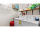 Bright laundry room with modern appliances and ample storage space on shelves at 1401 Berea Rd, Rougemont, NC 27572