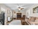 Cozy living room boasts brick fireplace, wood floors, and natural light creating a warm atmosphere at 1401 Berea Rd, Rougemont, NC 27572