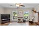 Comfortable living room with wood flooring and picturesque views creates a relaxing space at 1401 Berea Rd, Rougemont, NC 27572