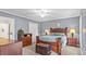 Main bedroom with elegant wooden furniture and neutral carpet at 1401 Berea Rd, Rougemont, NC 27572