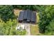 Aerial view of an outbuilding featuring covered bays for vehicle storage, nestled among green trees at 1401 Berea Rd, Rougemont, NC 27572