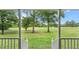 Porch view of the manicured lawn and verdant trees at 1401 Berea Rd, Rougemont, NC 27572