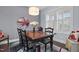 Elegant dining room featuring a dark wood table, stylish chairs, and ample natural light at 1448 Big Falls Dr, Wendell, NC 27591