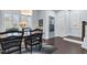 Bright dining area with a wooden table, dark chairs, and natural light streaming through shuttered windows at 1448 Big Falls Dr, Wendell, NC 27591