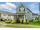 Stylish two-story home featuring a covered porch and lush landscaping, set in a desirable neighborhood at 1448 Big Falls Dr, Wendell, NC 27591