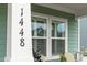 Close-up of the house number and decorative statue by the shuttered window at 1448 Big Falls Dr, Wendell, NC 27591