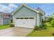 A detached garage featuring a white door and concrete driveway at 1448 Big Falls Dr, Wendell, NC 27591