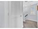 Bright hallway with carpeted floor, white doors, and modern lighting fixtures at 1448 Big Falls Dr, Wendell, NC 27591