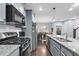 Charming kitchen features stainless steel appliances, granite countertops and gray cabinets at 1448 Big Falls Dr, Wendell, NC 27591