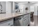 Kitchen island with stainless steel dishwasher, gray cabinets and granite countertops at 1448 Big Falls Dr, Wendell, NC 27591