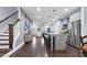 Modern, open-concept living space with a central kitchen island and stainless steel appliances, perfect for entertaining at 1448 Big Falls Dr, Wendell, NC 27591