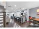 Stylish open floor plan with dark hardwood floors, seamlessly connecting the kitchen and living areas at 1448 Big Falls Dr, Wendell, NC 27591