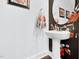 Stylish powder room with unique floral wallpaper and round mirror at 1448 Big Falls Dr, Wendell, NC 27591