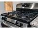 Close up of the stainless steel gas range with black top at 1448 Big Falls Dr, Wendell, NC 27591