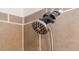 Close-up of a modern shower head with multiple spray settings in tiled bathroom at 1448 Big Falls Dr, Wendell, NC 27591
