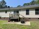 Back patio area with a fire pit and sliding door entrance, perfect for outdoor relaxation at 145 Country Walk Ln, Sanford, NC 27332