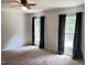 Cozy bedroom with neutral walls, plush carpet, a ceiling fan, and natural lighting at 145 Country Walk Ln, Sanford, NC 27332