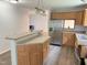 Kitchen with a breakfast bar, stainless steel refrigerator, and wood cabinets at 145 Country Walk Ln, Sanford, NC 27332
