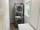 Laundry area features stacked washer and dryer, and window for natural light at 145 Country Walk Ln, Sanford, NC 27332