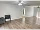 Spacious living room with wood floors, neutral paint, lots of natural light, and modern ceiling fan at 145 Country Walk Ln, Sanford, NC 27332