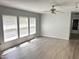 Spacious living room with wood-look floors, ceiling fan, and lots of natural light at 145 Country Walk Ln, Sanford, NC 27332