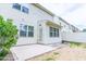 White vinyl siding and open patio of the backyard with green bushes at 145 Torrey Heights Ln, Durham, NC 27703