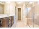 Bright bathroom featuring a dark wood vanity and tiled walk-in shower with glass door at 145 Torrey Heights Ln, Durham, NC 27703