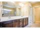 Bright bathroom featuring a long countertop, double sinks, and walk-in shower at 145 Torrey Heights Ln, Durham, NC 27703
