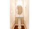 Pedestal sink in half bath with oval mirror and modern lighting at 145 Torrey Heights Ln, Durham, NC 27703