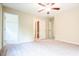 Spacious bedroom features neutral carpet, ceiling fan, multiple doors to closets and bathrooms at 145 Torrey Heights Ln, Durham, NC 27703