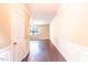 Bright foyer with hardwood floors, classic wall trim, and a view into the living area at 145 Torrey Heights Ln, Durham, NC 27703