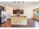 Modern kitchen featuring a breakfast bar, stainless steel appliances, and dark wood cabinetry at 145 Torrey Heights Ln, Durham, NC 27703