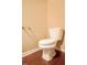 Toilet in cozy half-bath with warm paint and wood-style flooring at 145 Torrey Heights Ln, Durham, NC 27703