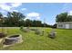 Expansive backyard offering a fire pit, garden, storage shed and mature trees at 15 Scuppernong Ln, Lillington, NC 27546