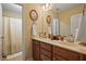 Bathroom featuring a combination shower and tub and dual sink vanity at 15 Scuppernong Ln, Lillington, NC 27546