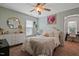 Bright bedroom featuring neutral tones, a ceiling fan, and a walk-in closet at 15 Scuppernong Ln, Lillington, NC 27546