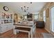 Bright dining room with a rustic table set, hardwood floors, flowing into the comfortable living area at 15 Scuppernong Ln, Lillington, NC 27546