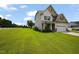Charming two-story home featuring a manicured lawn and a convenient two-car garage at 15 Scuppernong Ln, Lillington, NC 27546