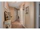 Well-lit hallway with neutral walls, carpet flooring, and decorative sconces creating a warm, inviting atmosphere at 15 Scuppernong Ln, Lillington, NC 27546