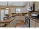 A view of the kitchen featuring granite countertops, stainless steel appliances, and wooden cabinets at 15 Scuppernong Ln, Lillington, NC 27546