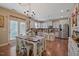 Charming kitchen with stainless steel appliances, granite countertops, and a dining area with a farmhouse-style table at 15 Scuppernong Ln, Lillington, NC 27546