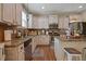Kitchen featuring stainless steel appliances, granite countertops, a kitchen island and wooden cabinets at 15 Scuppernong Ln, Lillington, NC 27546