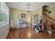 Cozy living room featuring hardwood floors, a decorative table, and staircase at 15 Scuppernong Ln, Lillington, NC 27546