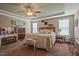 Cozy bedroom with a tray ceiling, ceiling fan, and coordinated decor and bedding creating a comfortable retreat at 15 Scuppernong Ln, Lillington, NC 27546