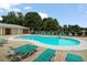 Sparkling community pool area with comfortable lounge chairs for relaxation at 15 Scuppernong Ln, Lillington, NC 27546